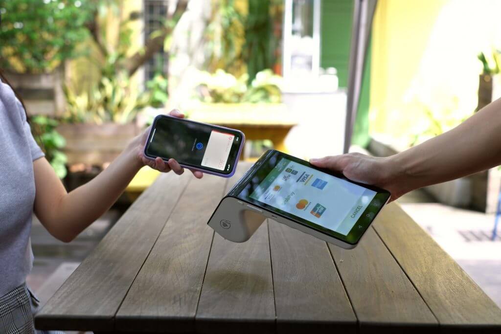 Cafe owner using EFTPOS payment system on the Gold Coast